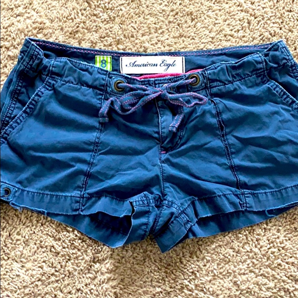 Navy blue cargo shorts with ties.